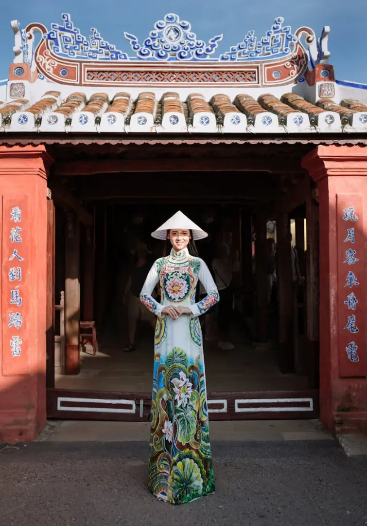 Photo by Võ Văn Tiến Portrait of a woman in an ao dai in Hội An, showcasing Vietnamese culture and heritage.