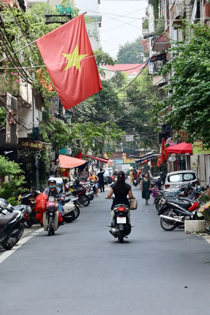 Photo by Ekaterina Boltaga A person riding a motorcycle down a street