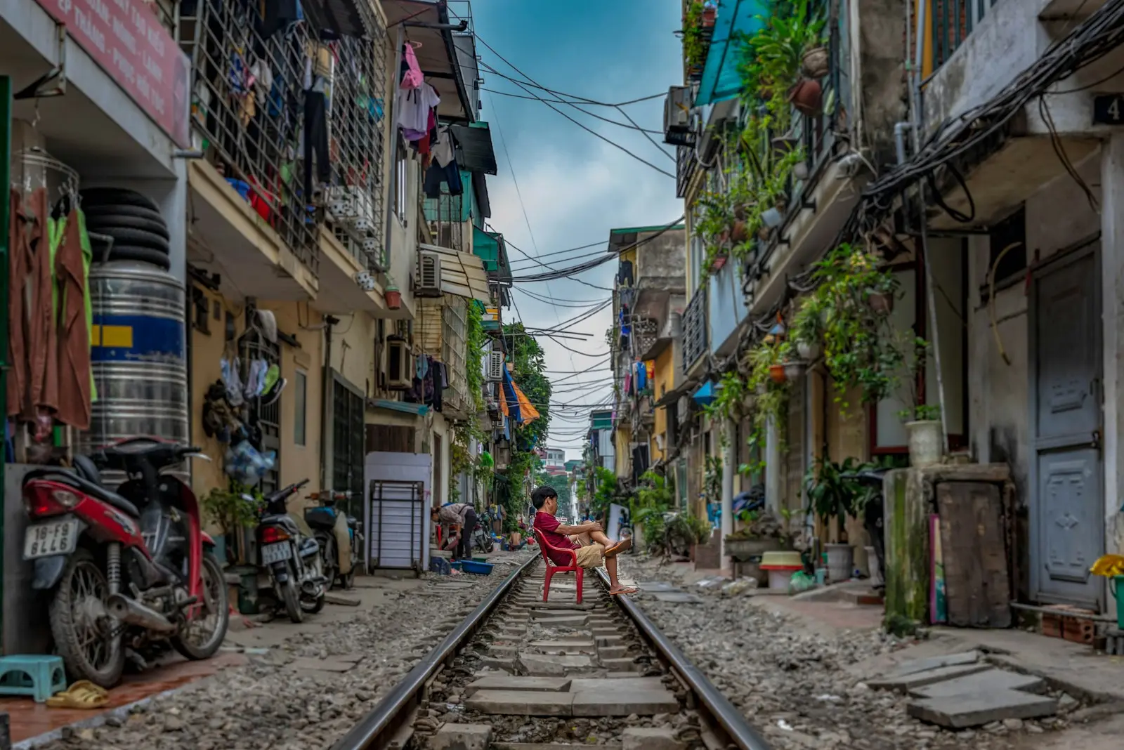 Photo by Chor Tsang man sitting on railway