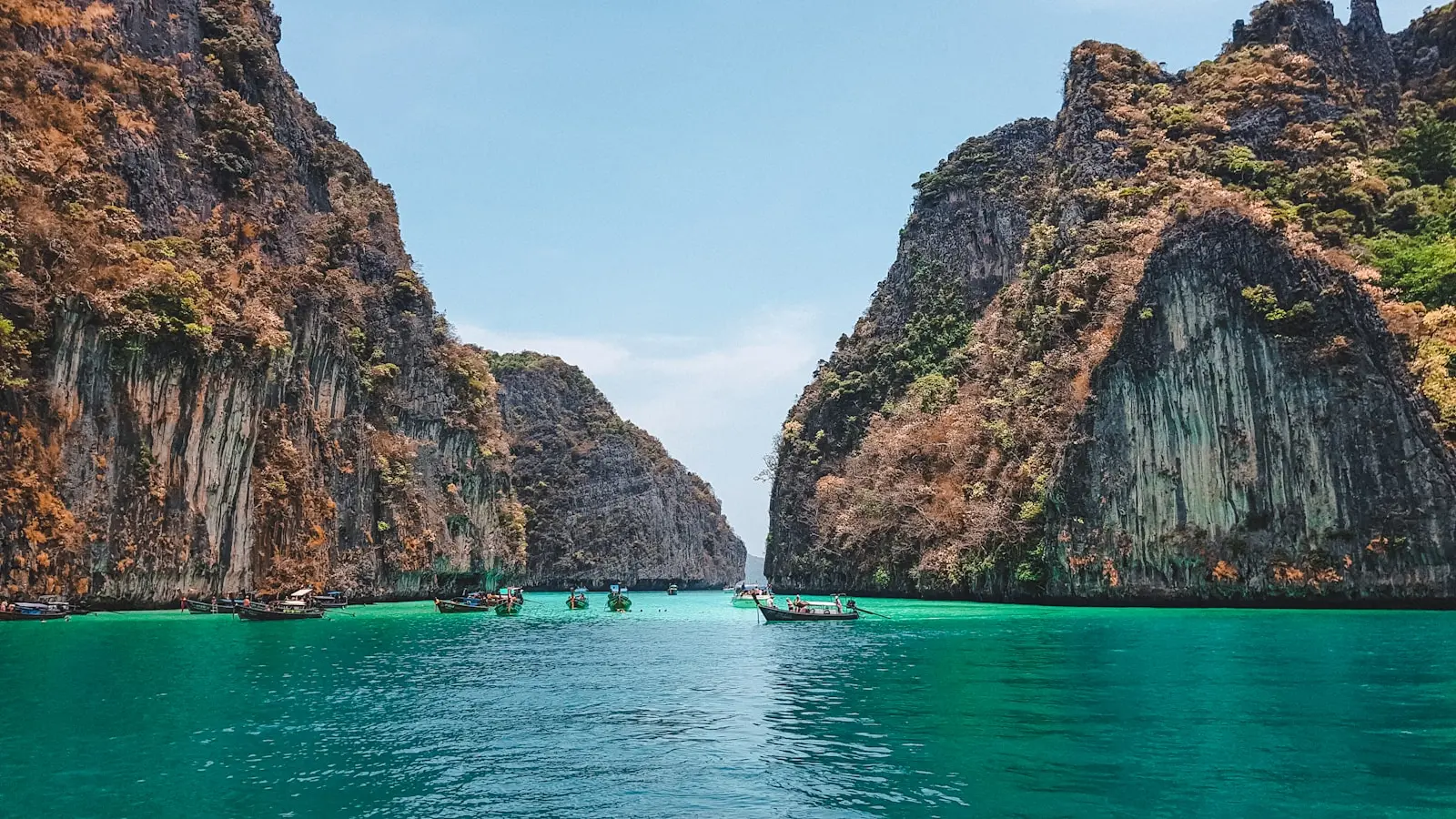 Photo by Miltiadis Fragkidis boat on water near brown rock formation during daytime