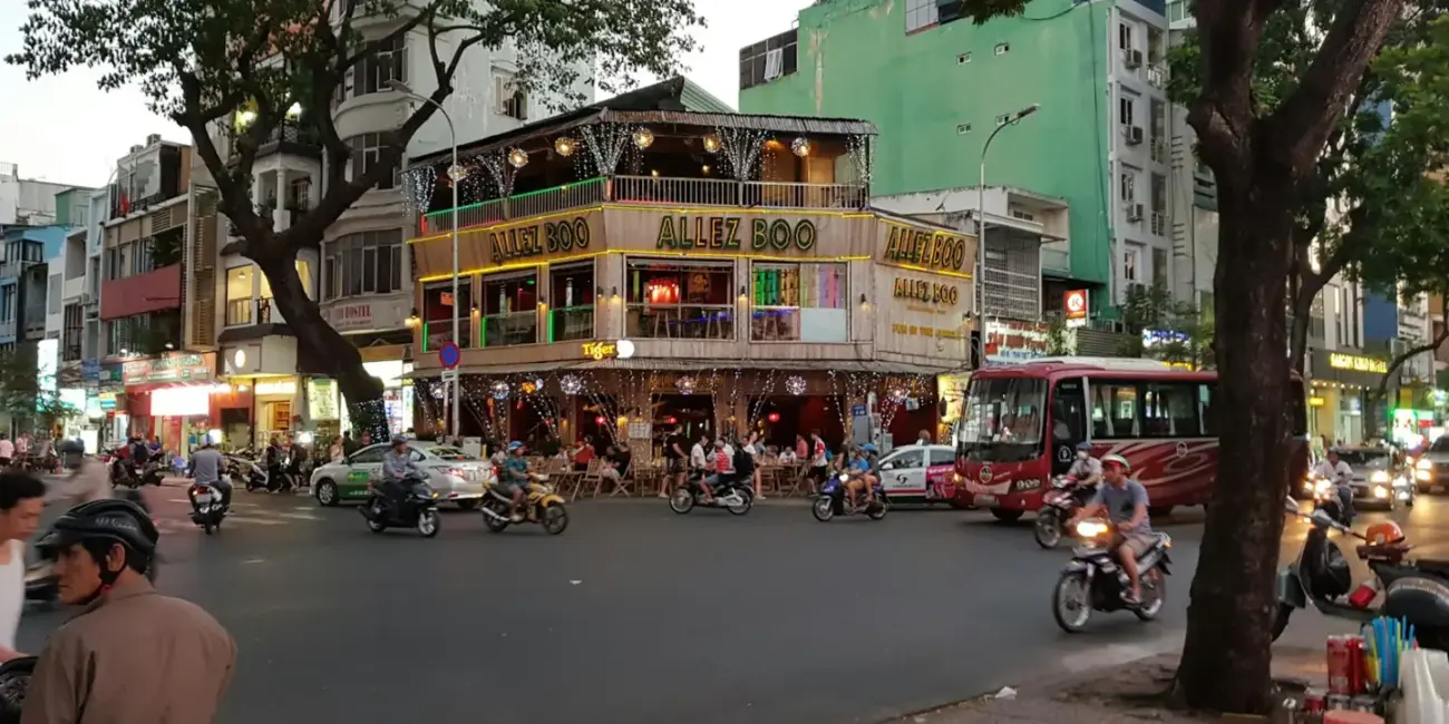 Busy city street corner with traffic and pedestrians