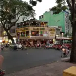 Busy city street corner with traffic and pedestrians