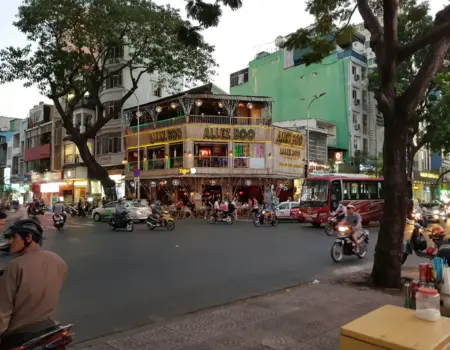 Busy city street corner with traffic and pedestrians