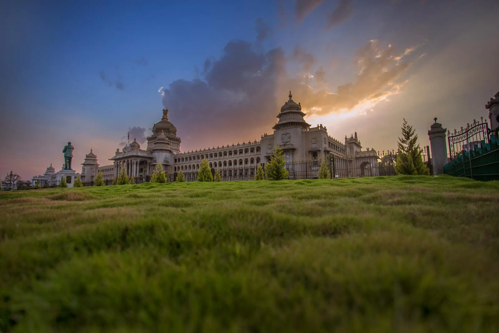 Capture of Vidhana Soudha in Bengaluru with a vibrant sunset sky, showcasing beautiful architecture.