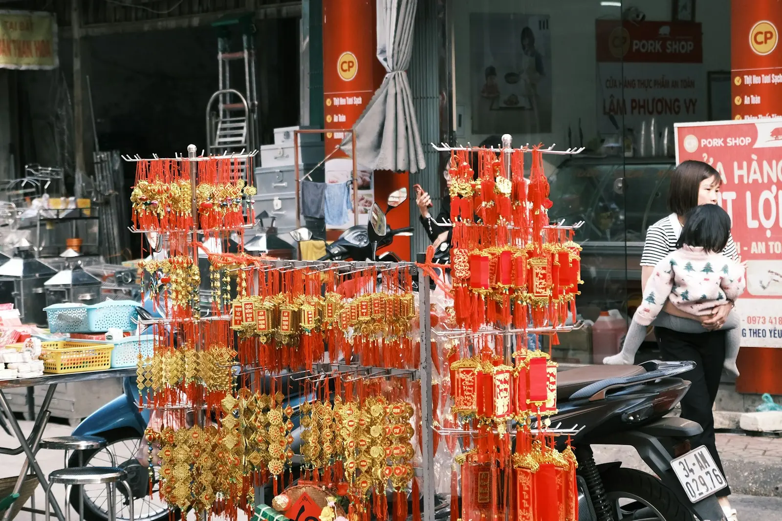 Red decorations are displayed in a bustling market.