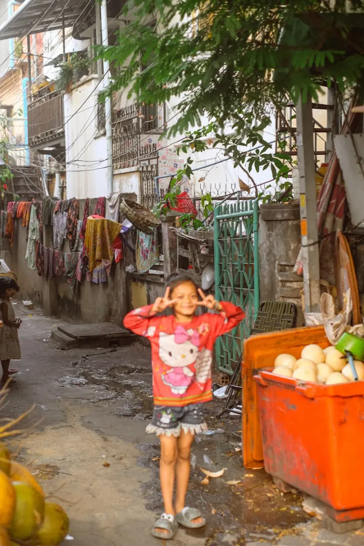 Young girl in a hello kitty shirt makes peace sign