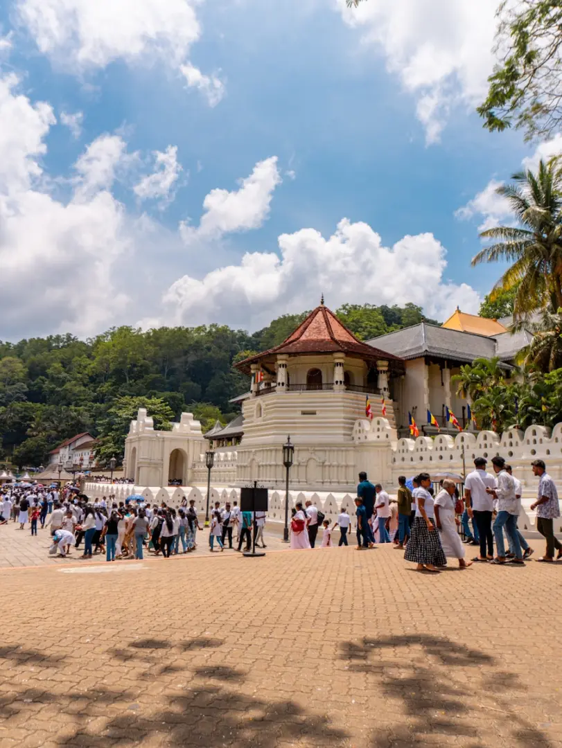 A temple with people and a cloudy sky.