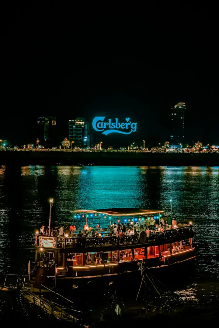 a boat with people on it floating in the water