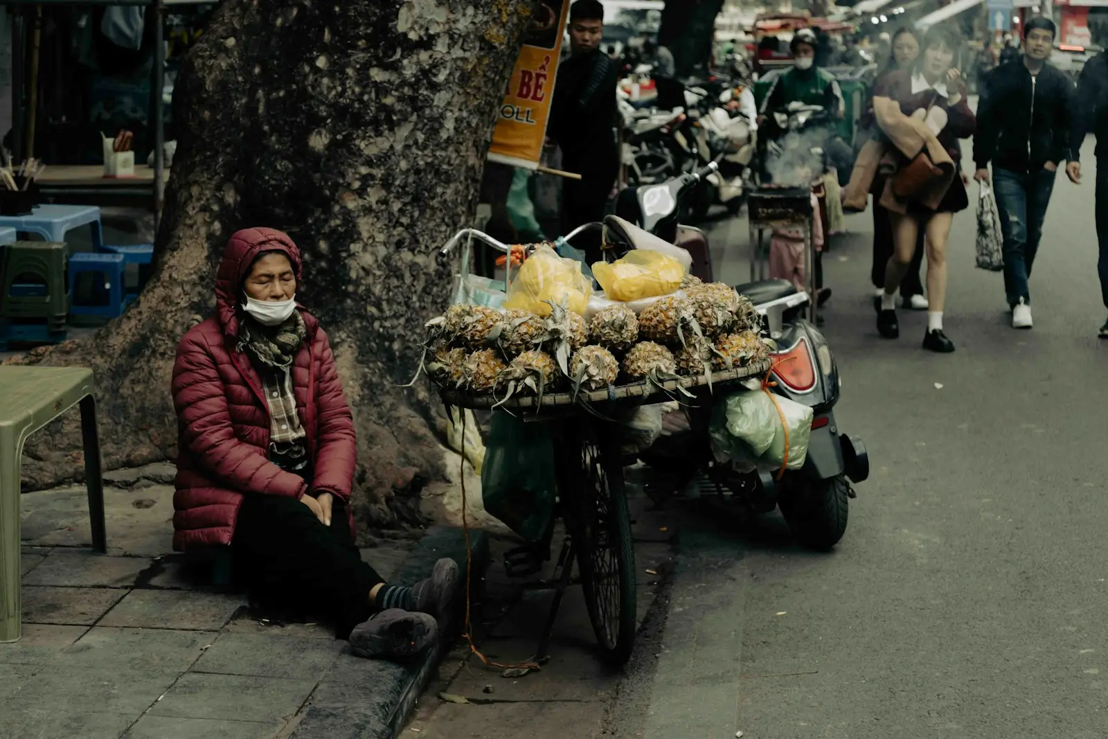Woman selling fruit on a city street.