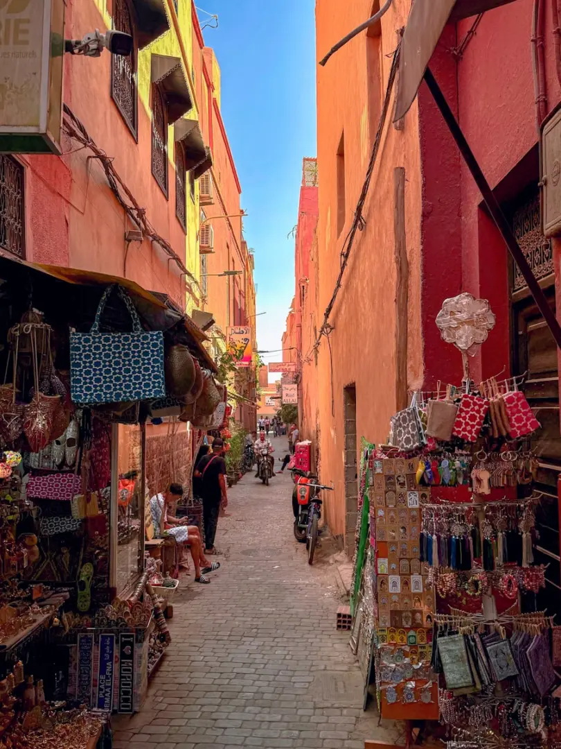 Narrow street lined with shops and people