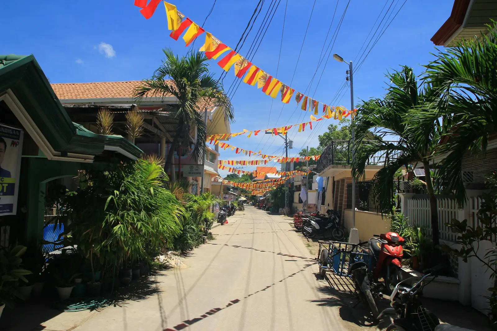 A street is decorated with colorful banners.