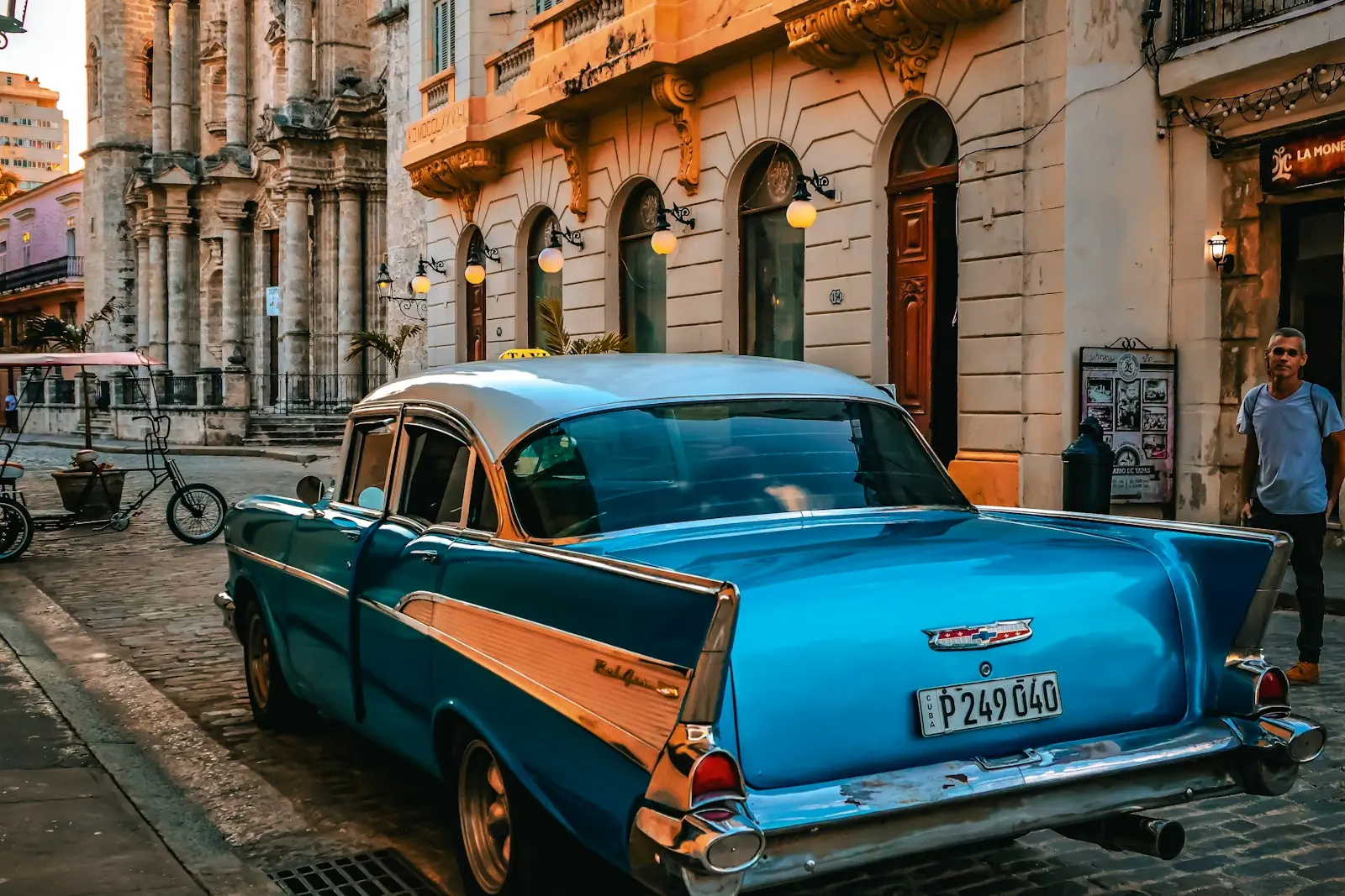 A classic car is parked on a cuban street.