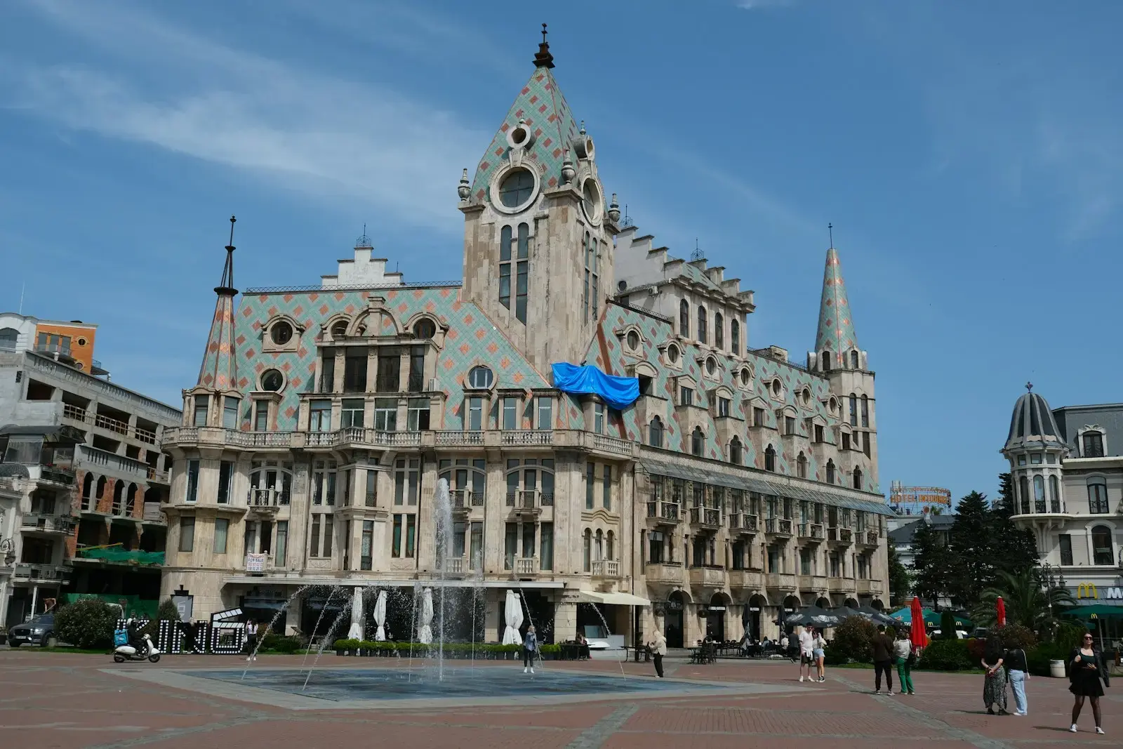 A large building with a fountain in front of it