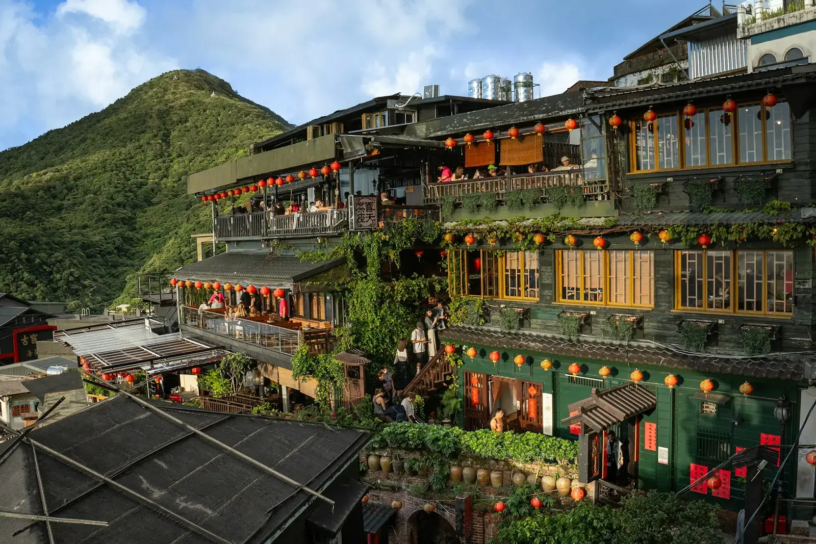 A group of buildings with a mountain in the background