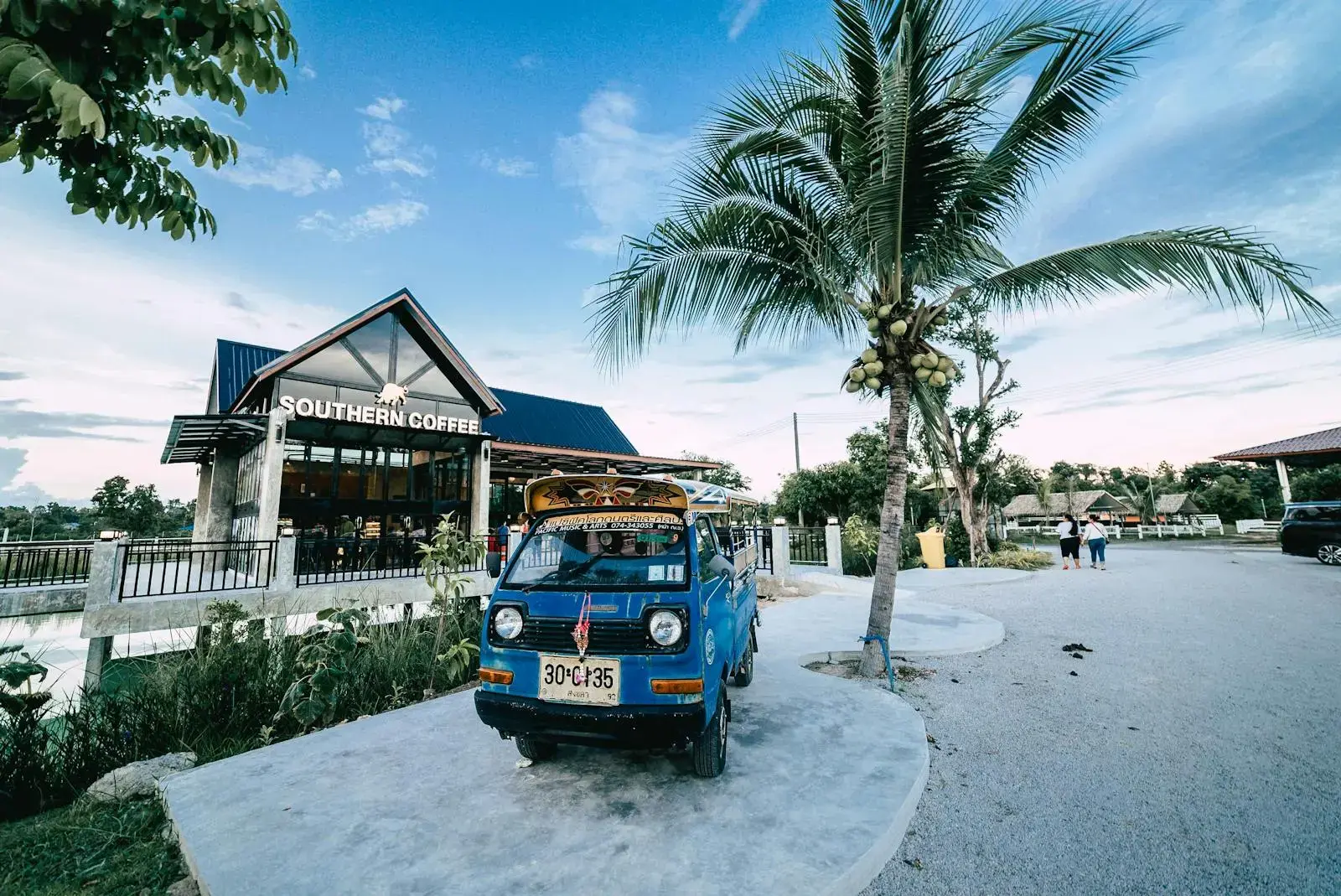 Scenic view of Southern Coffee shop and vintage blue truck in Mukdahan, Thailand.