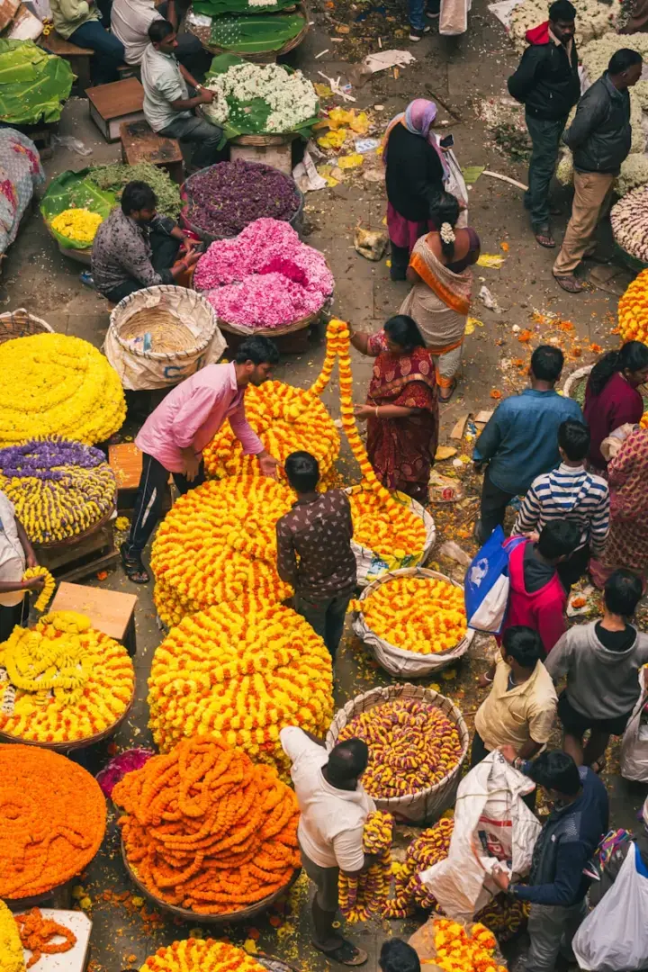 Photo by Gayatri Malhotra a group of people standing around a bunch of flowers