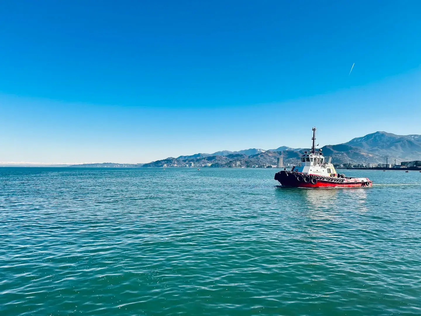 A boat floating on top of a large body of water