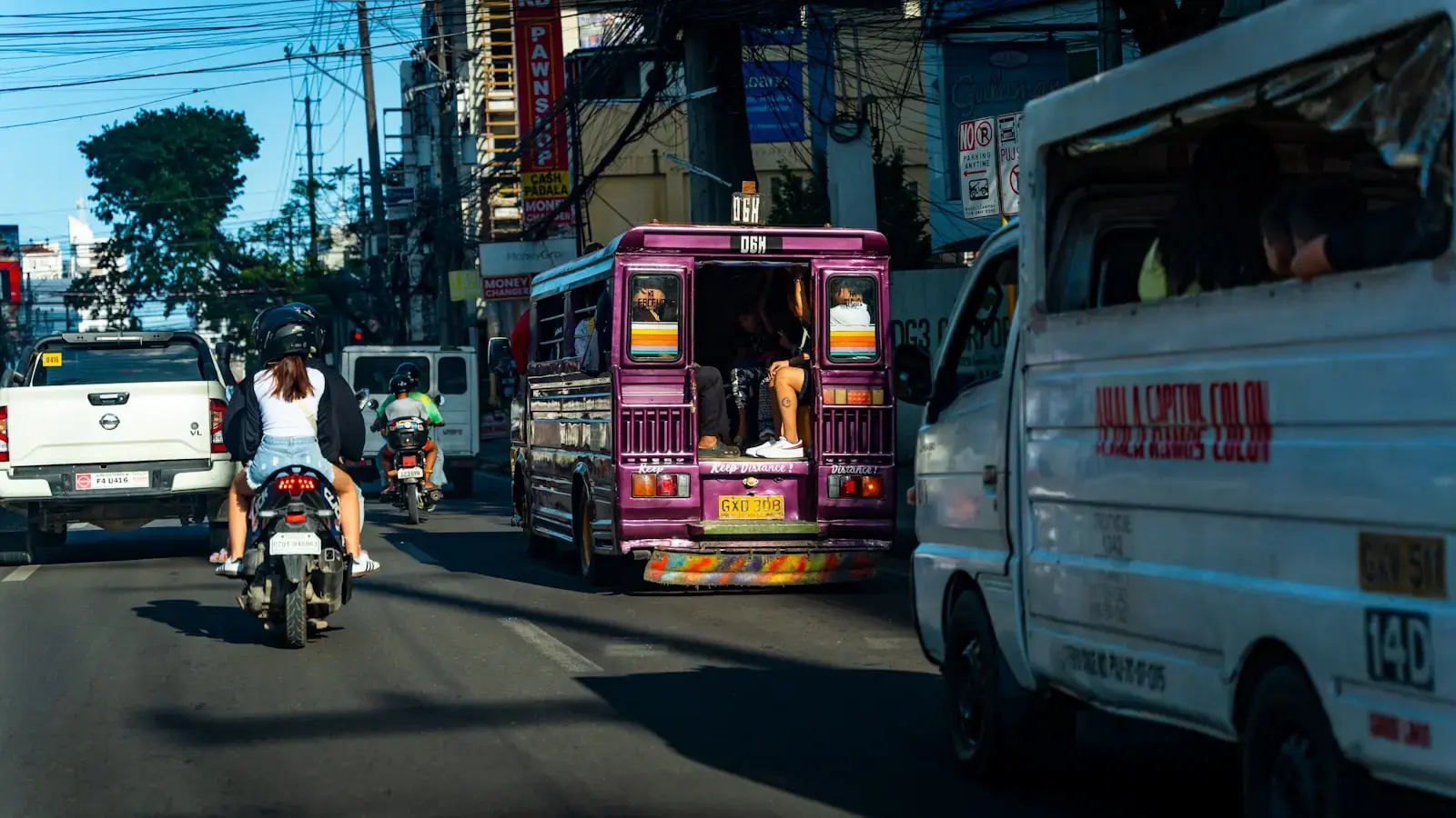 Photo by XT7 Core a man riding a motorcycle down a busy street