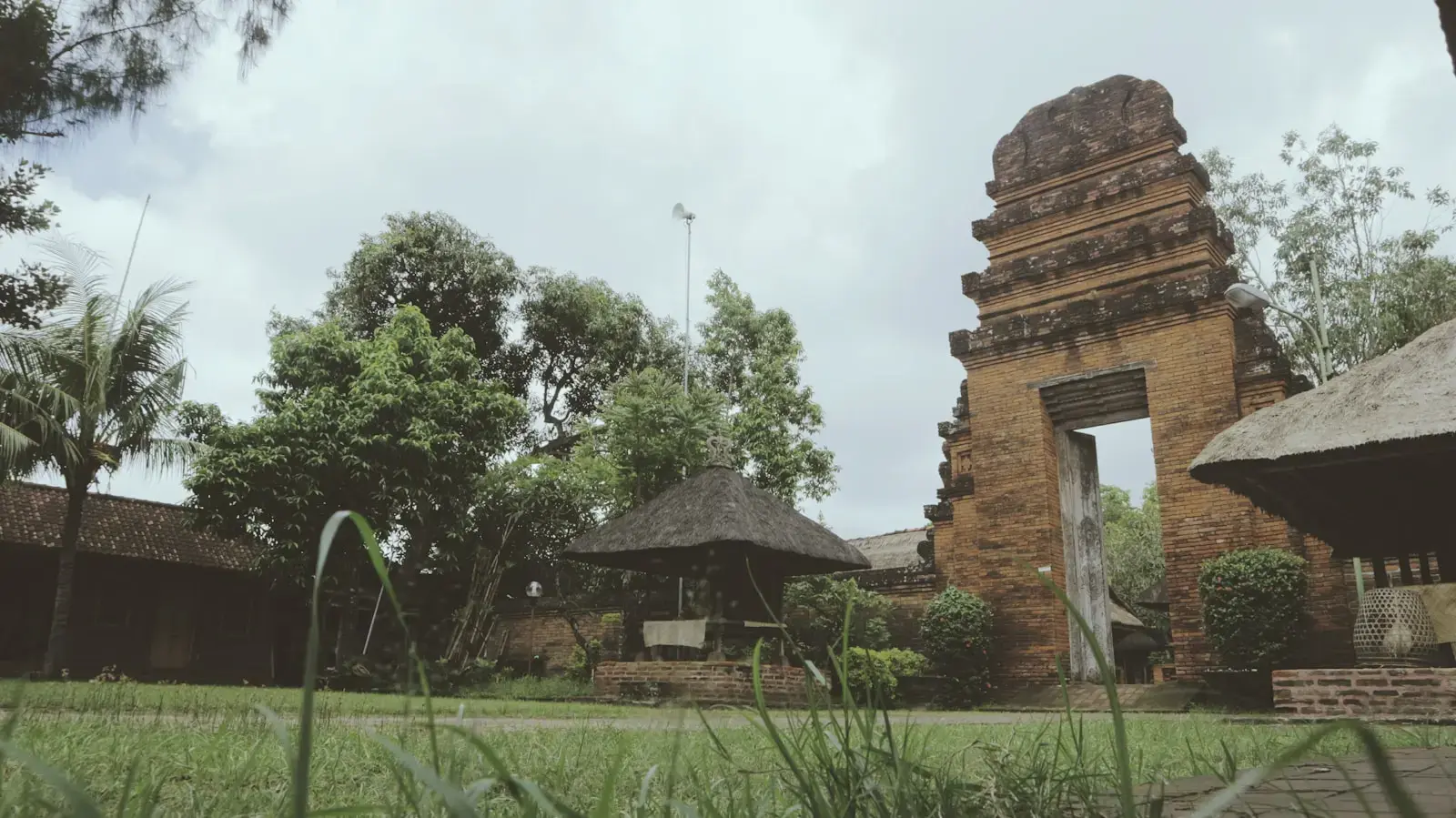 Photo by I Nyoman Yuda Wirawan a stone building with a grass yard