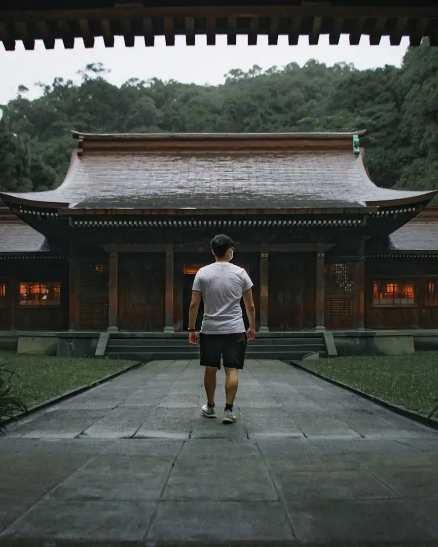 a man standing in front of a building