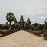 A stone walkway leading to a large building