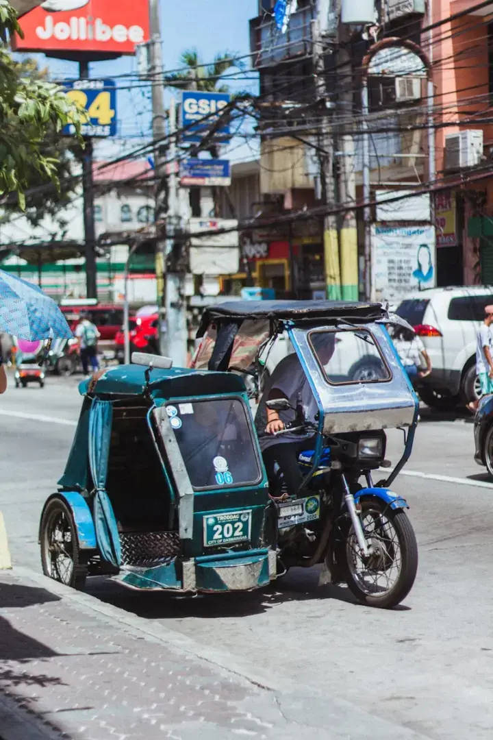 Photo by Lance Lozano blue and black mini cooper on road during daytime