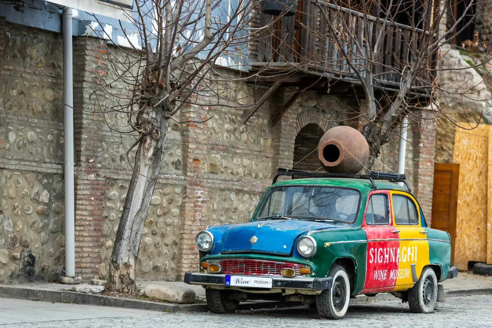 Colorful vintage car with clay pot on roof