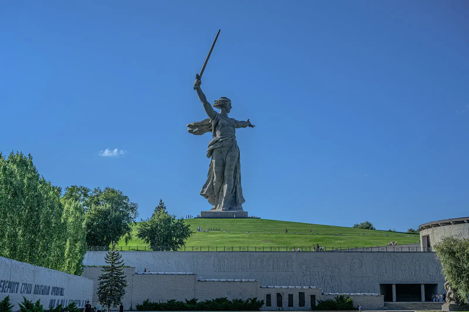 a statue of a woman holding a sword in front of a building