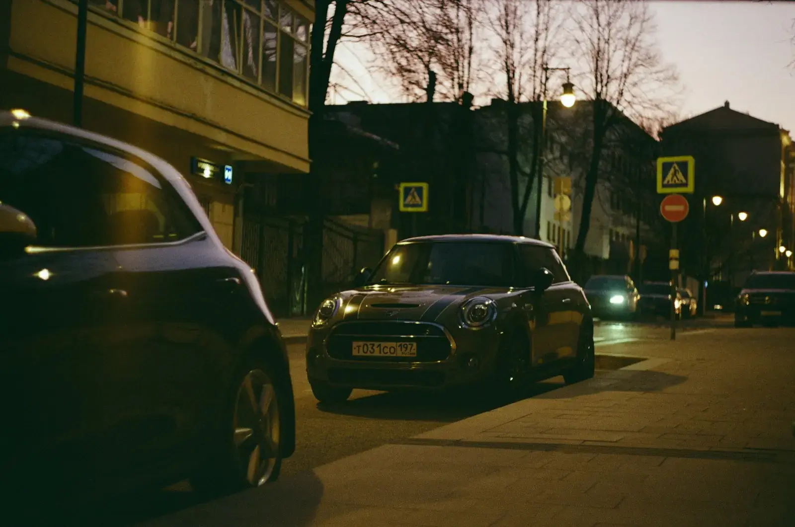 Photo by Evgeniy Bezkorovayniy Cars are driving on a street at dusk.