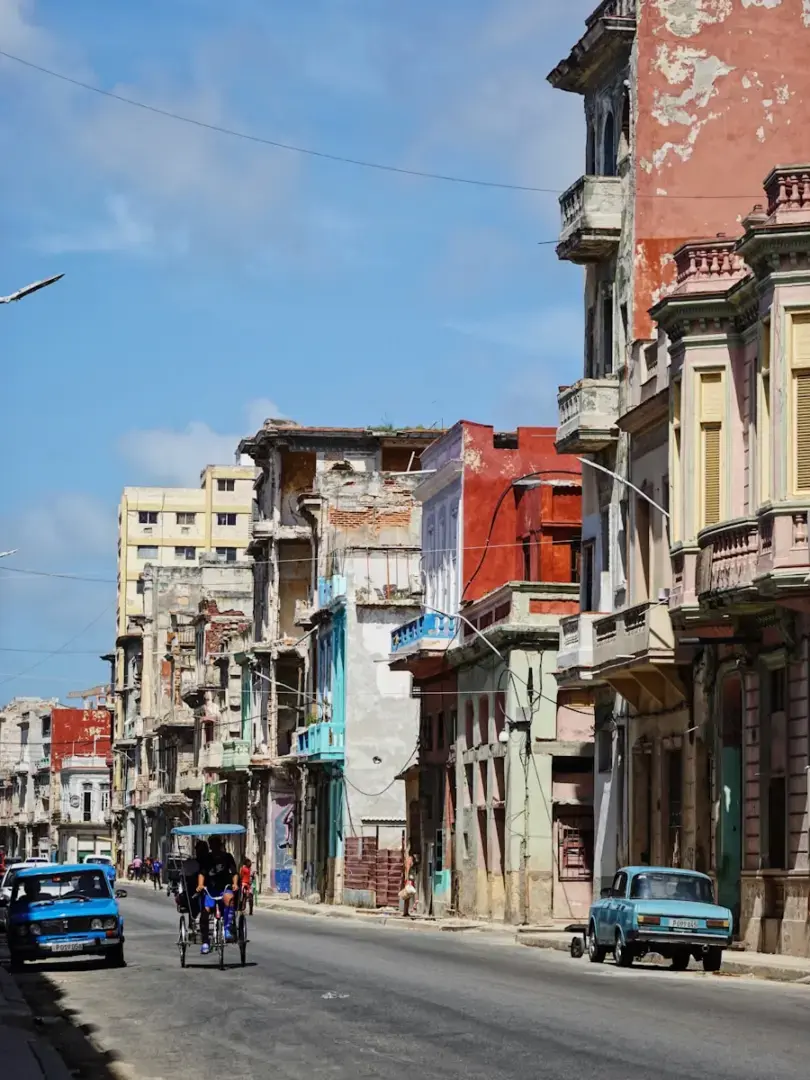 A city street with cars and people on bicycles