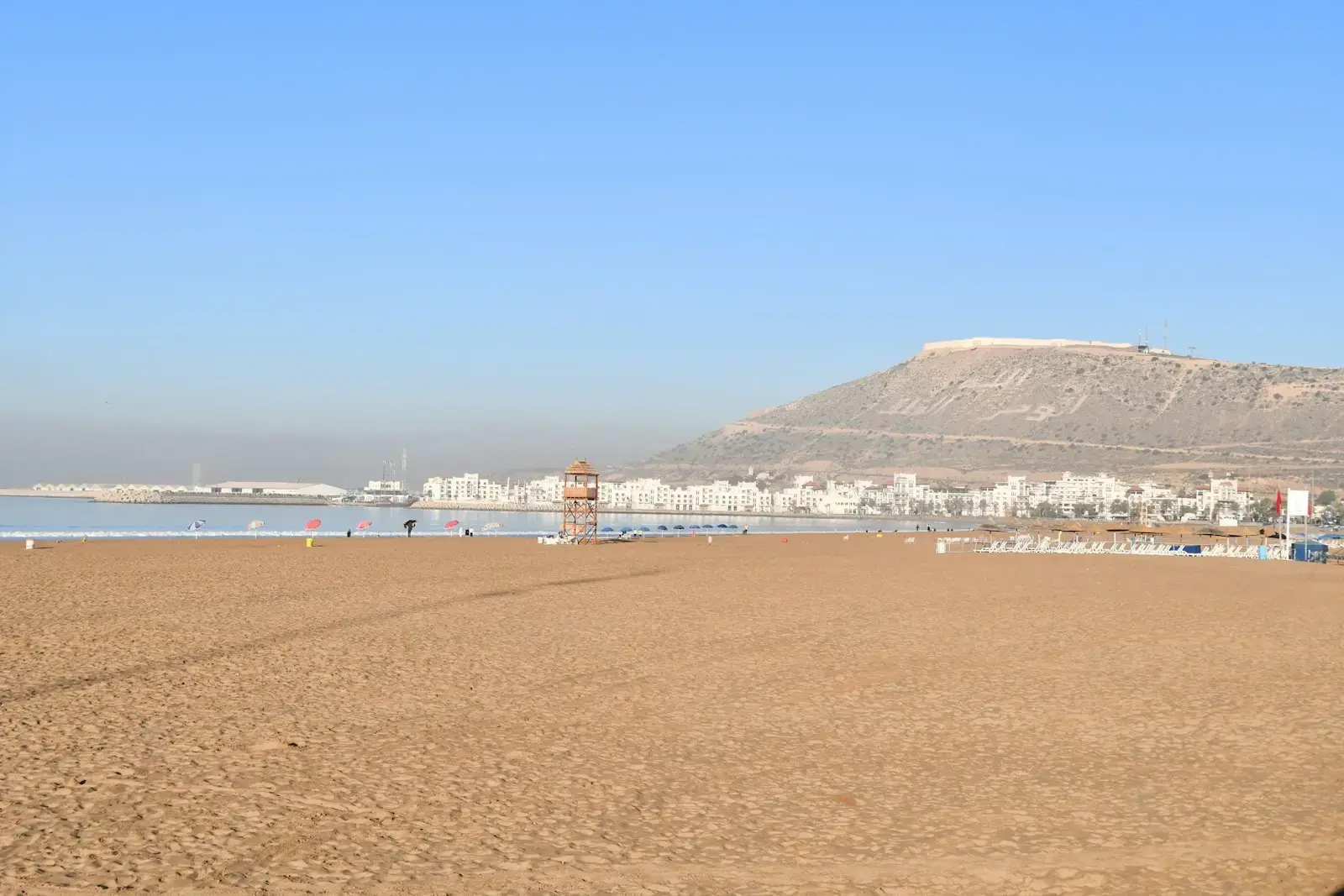 Photo by SnapSaga a beach with a mountain in the background