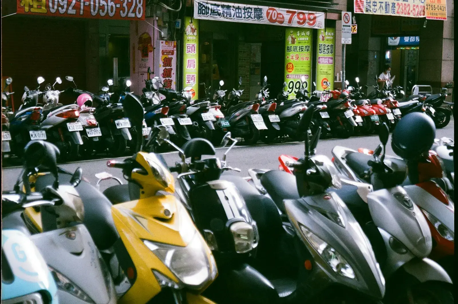 Photo by Faye Yu a group of motorcycles parked in a parking lot