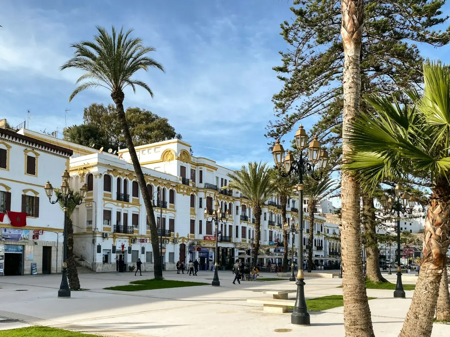 a large white building surrounded by palm trees