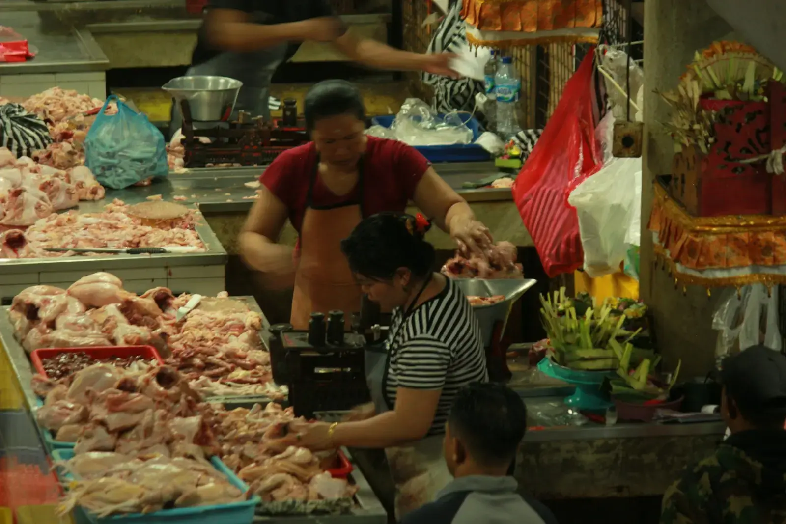 A group of people standing around a food market