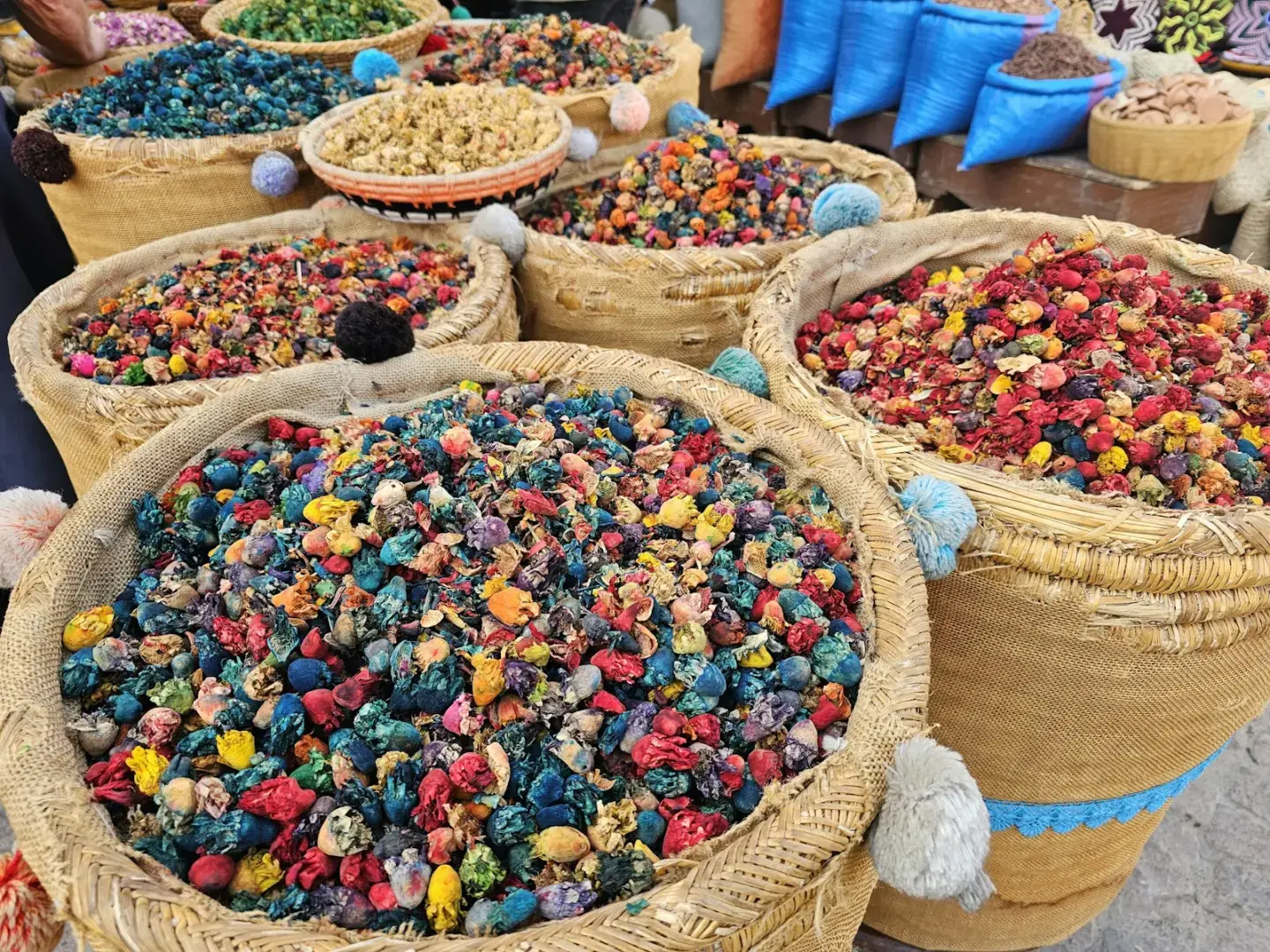 Photo by Hasmik Ghazaryan Olson Baskets of colorful dried flower petals and spices.