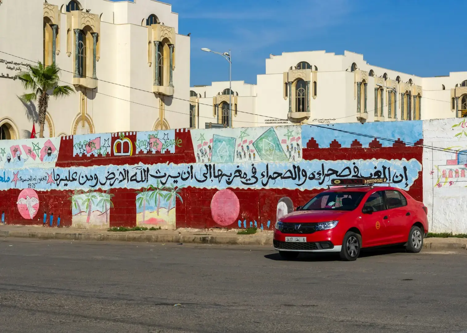 a red car parked on the side of a road