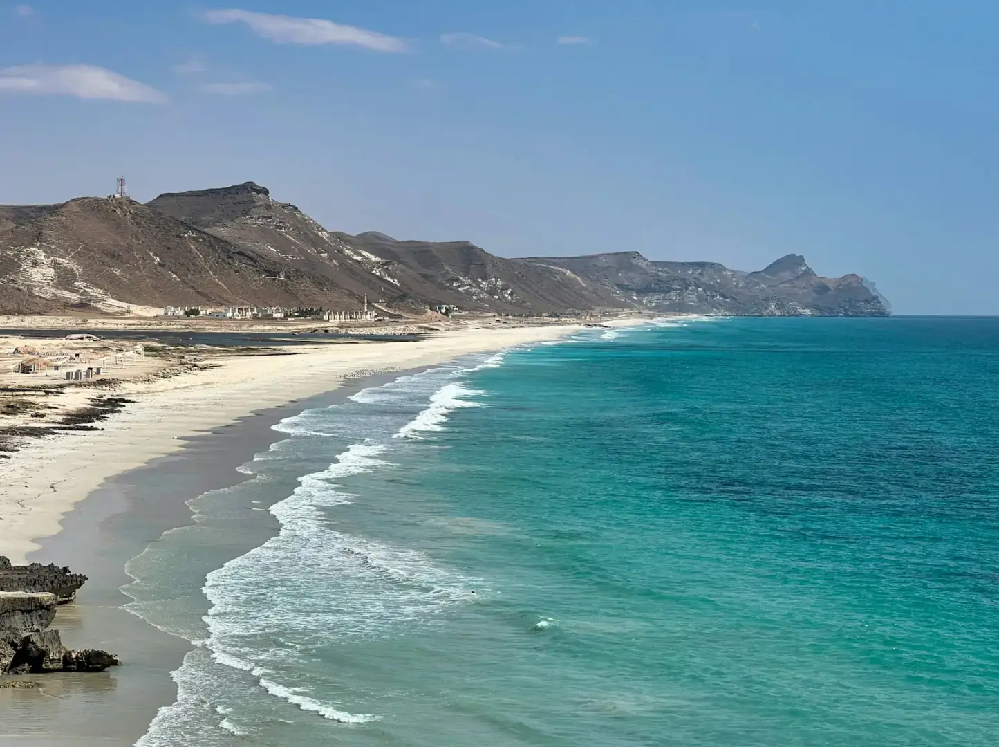 a view of a beach with a mountain in the background
