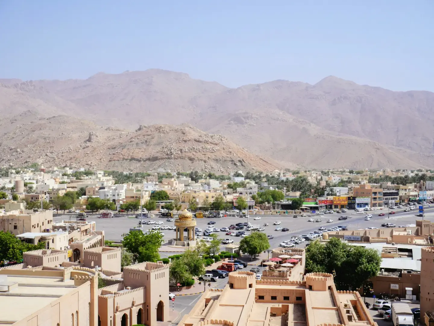 Desert town with mountains and a busy road