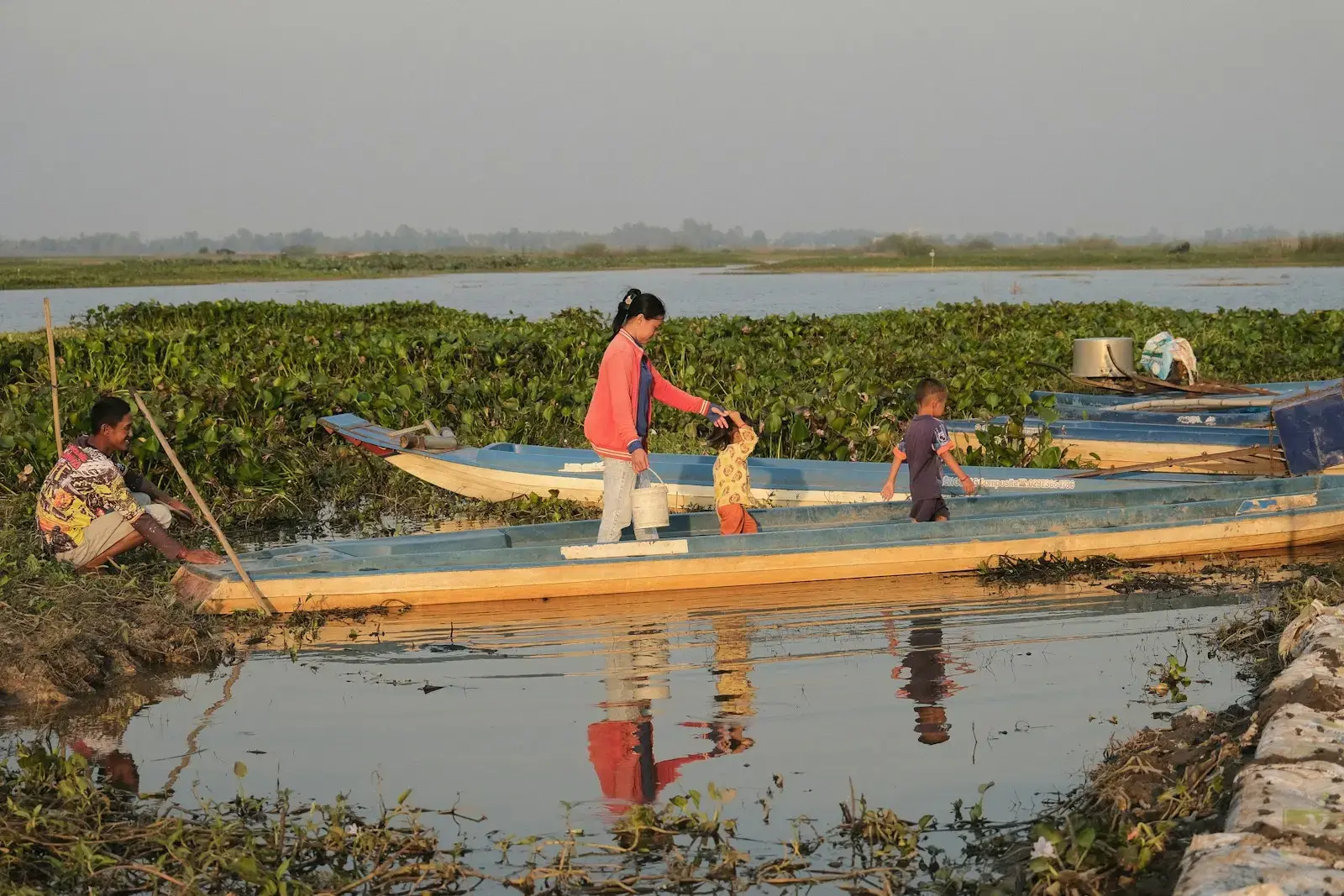 Photo by Siborey Sean A group of people on a boat in a body of water