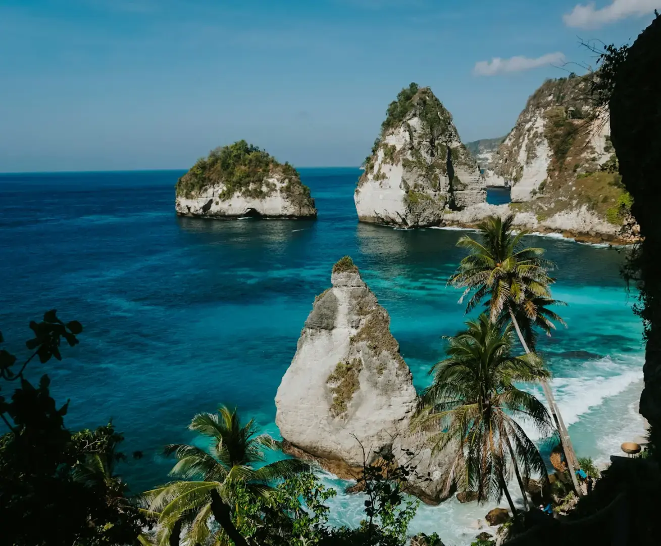 Tropical island cliffs with clear blue ocean water