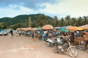 Photo by SAM sokkolinmony Outdoor market with stalls, motorcycles, and people
