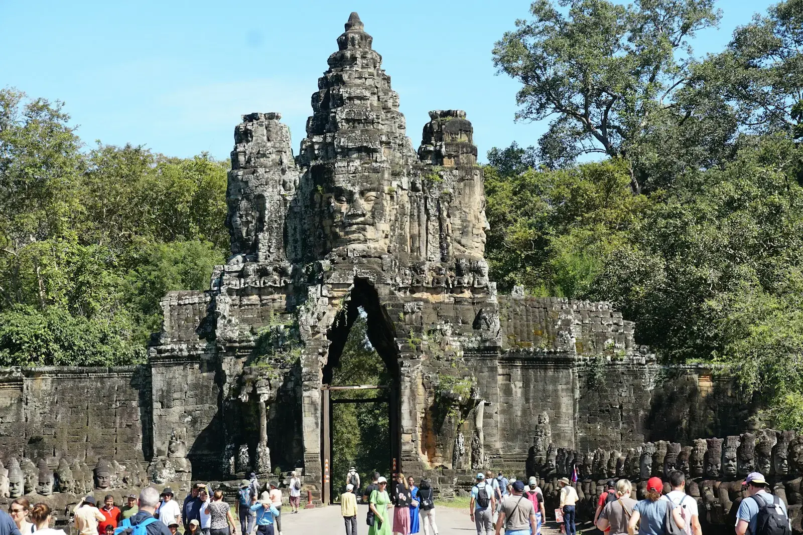 Photo by Sheila C A group of people walking around a stone structure