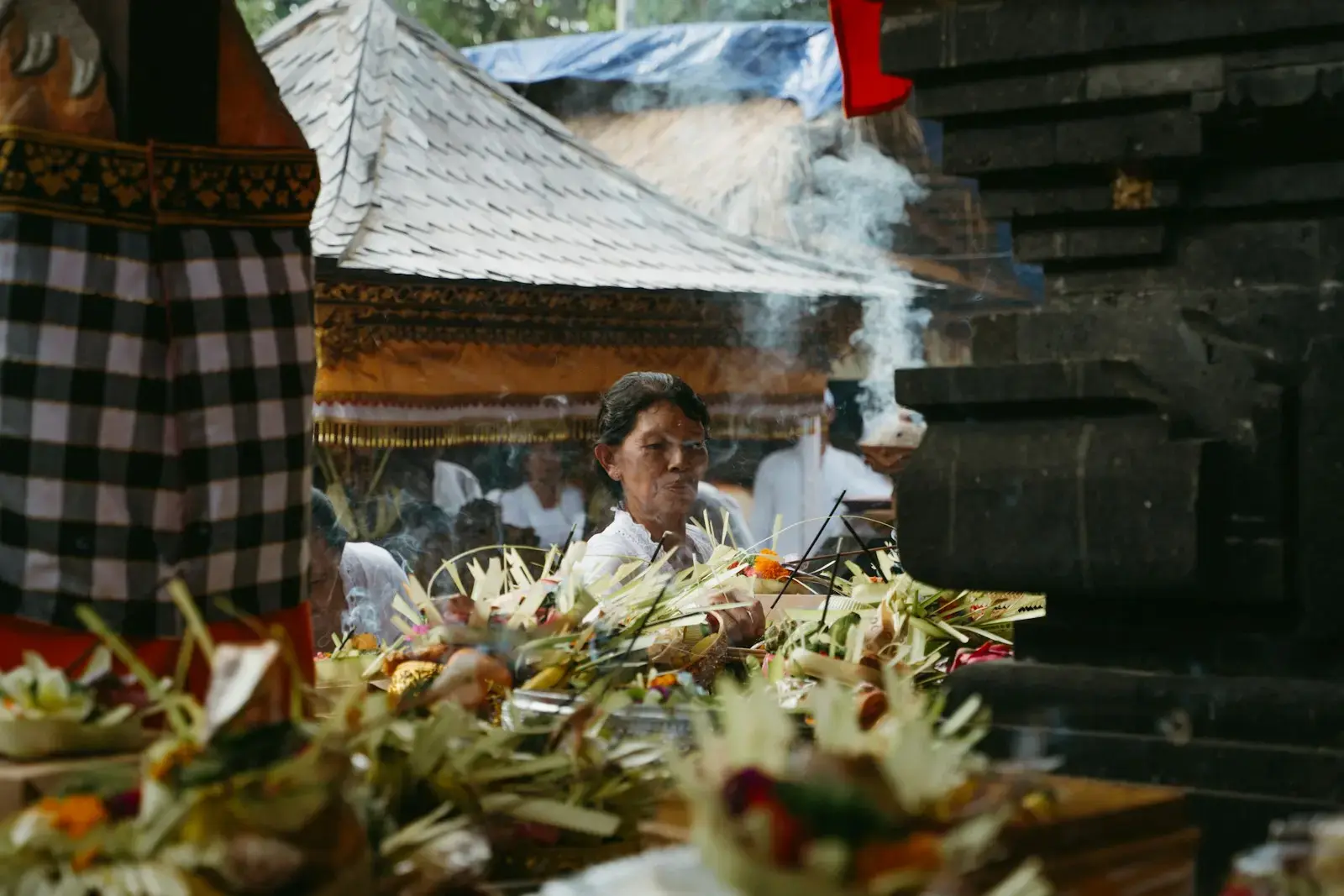 People gathered around offerings at a temple