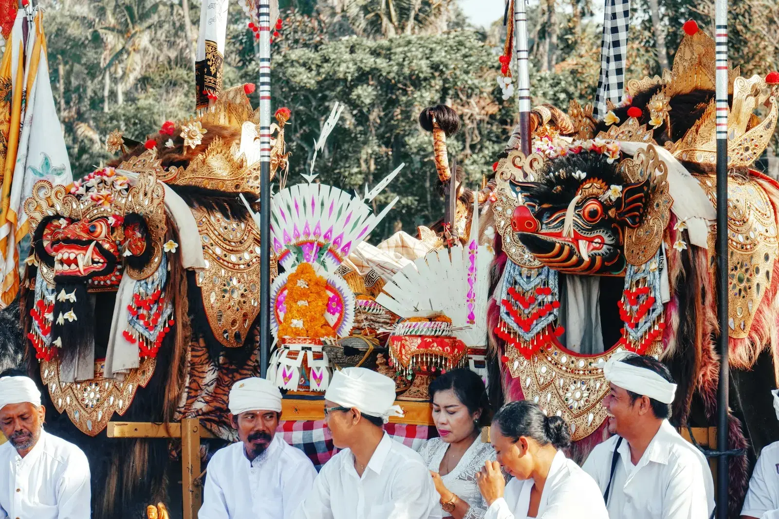 People in traditional attire at a festival with elaborate masks