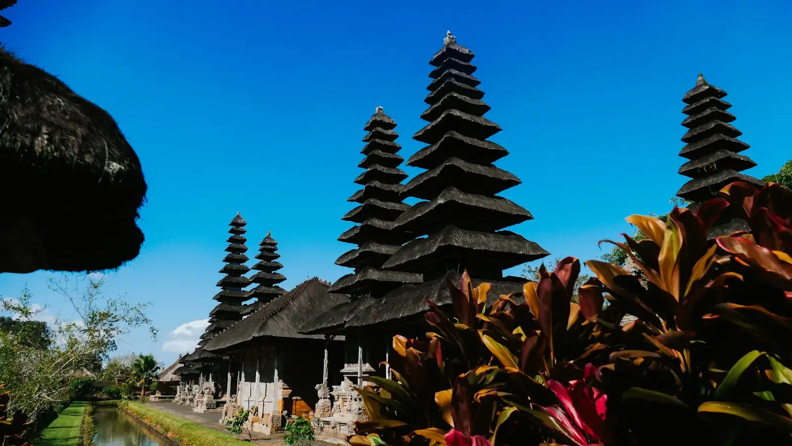 Tall tiered temples under a bright blue sky.