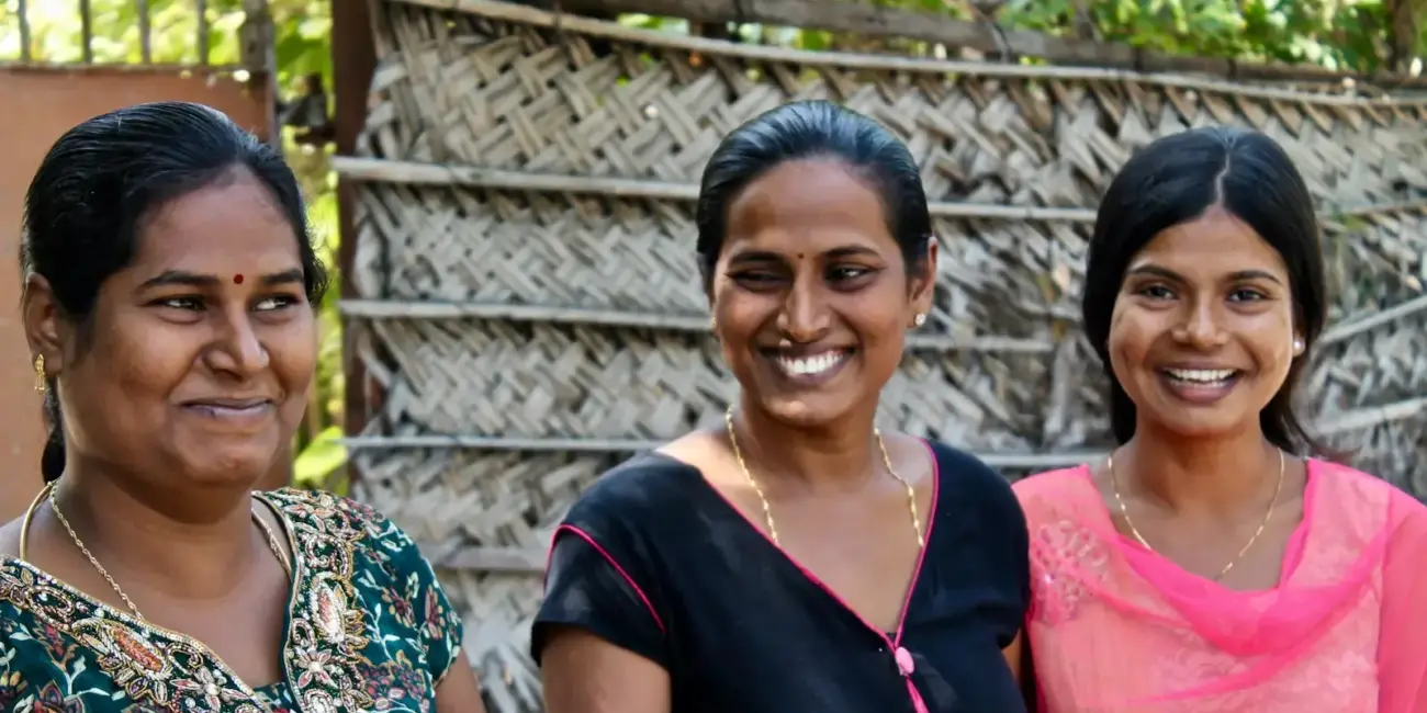 three women wearing assorted-color shirts
