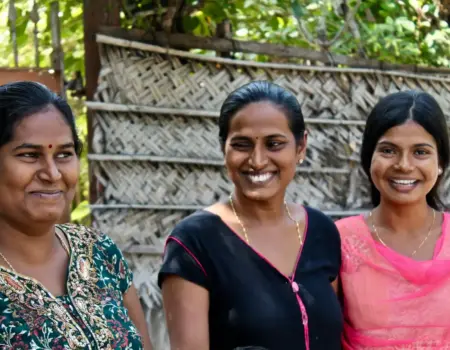 three women wearing assorted-color shirts