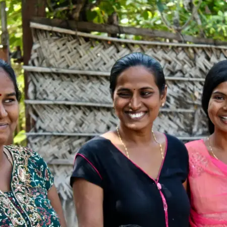 three women wearing assorted-color shirts