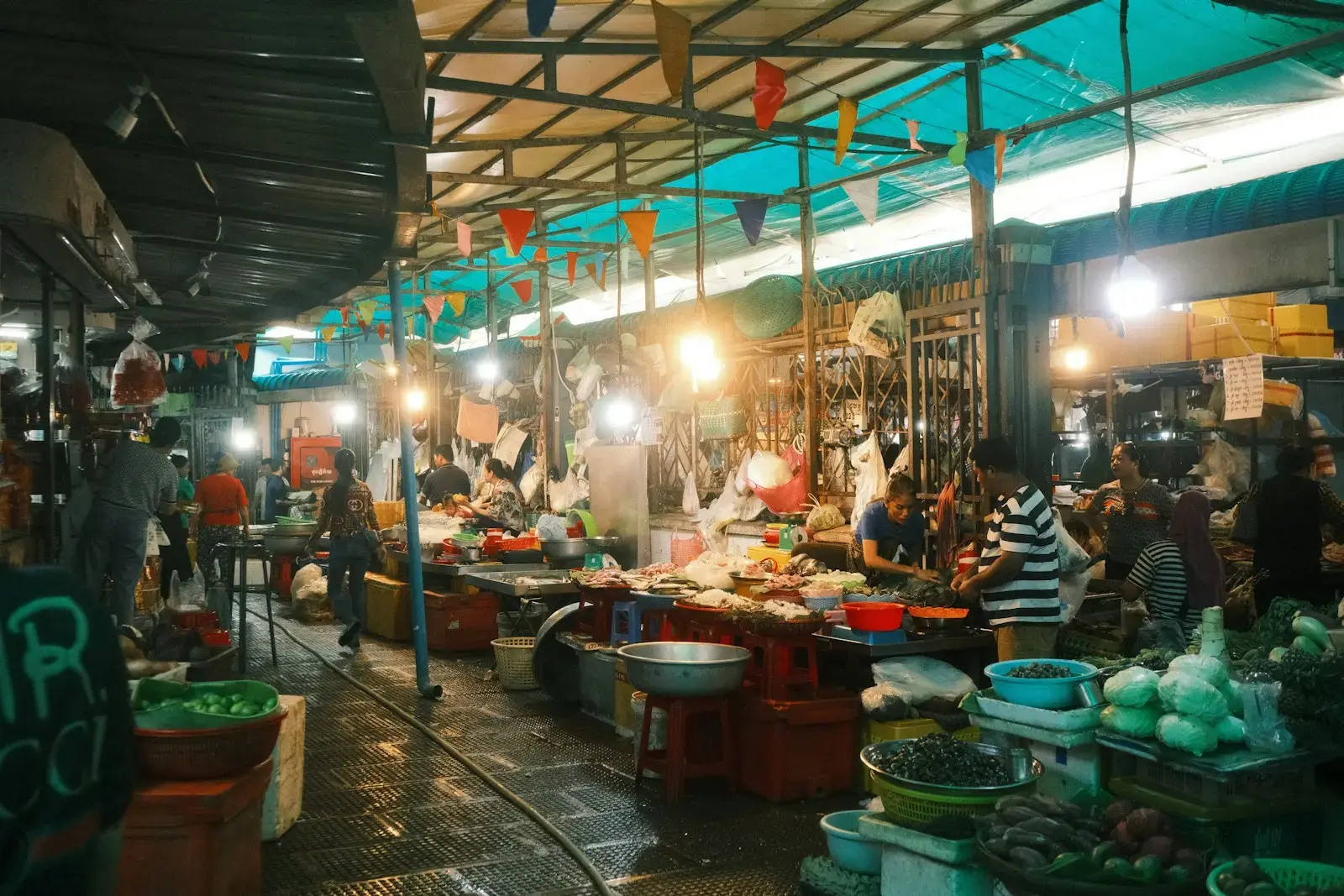 A group of people standing around a market