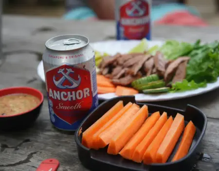 a plate of food and a can of soda